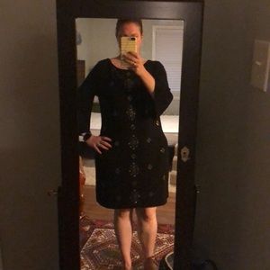 Black dress with metallic embellishments.